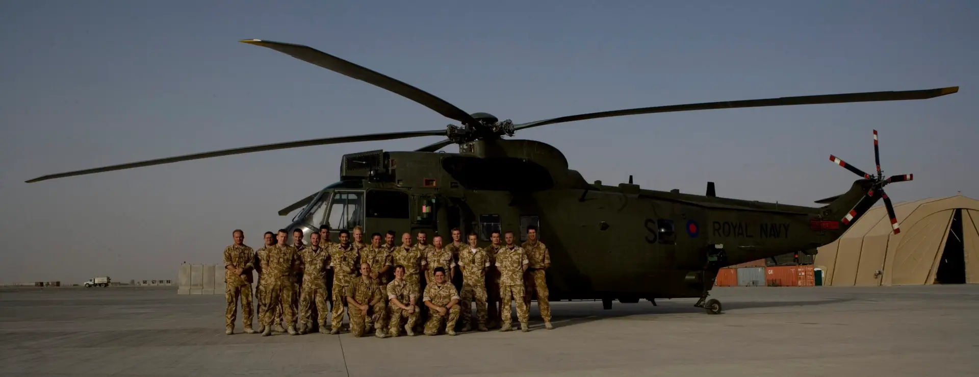 A picture of Mark Lavallee in Afghanistan in front of a Seaking helicopter